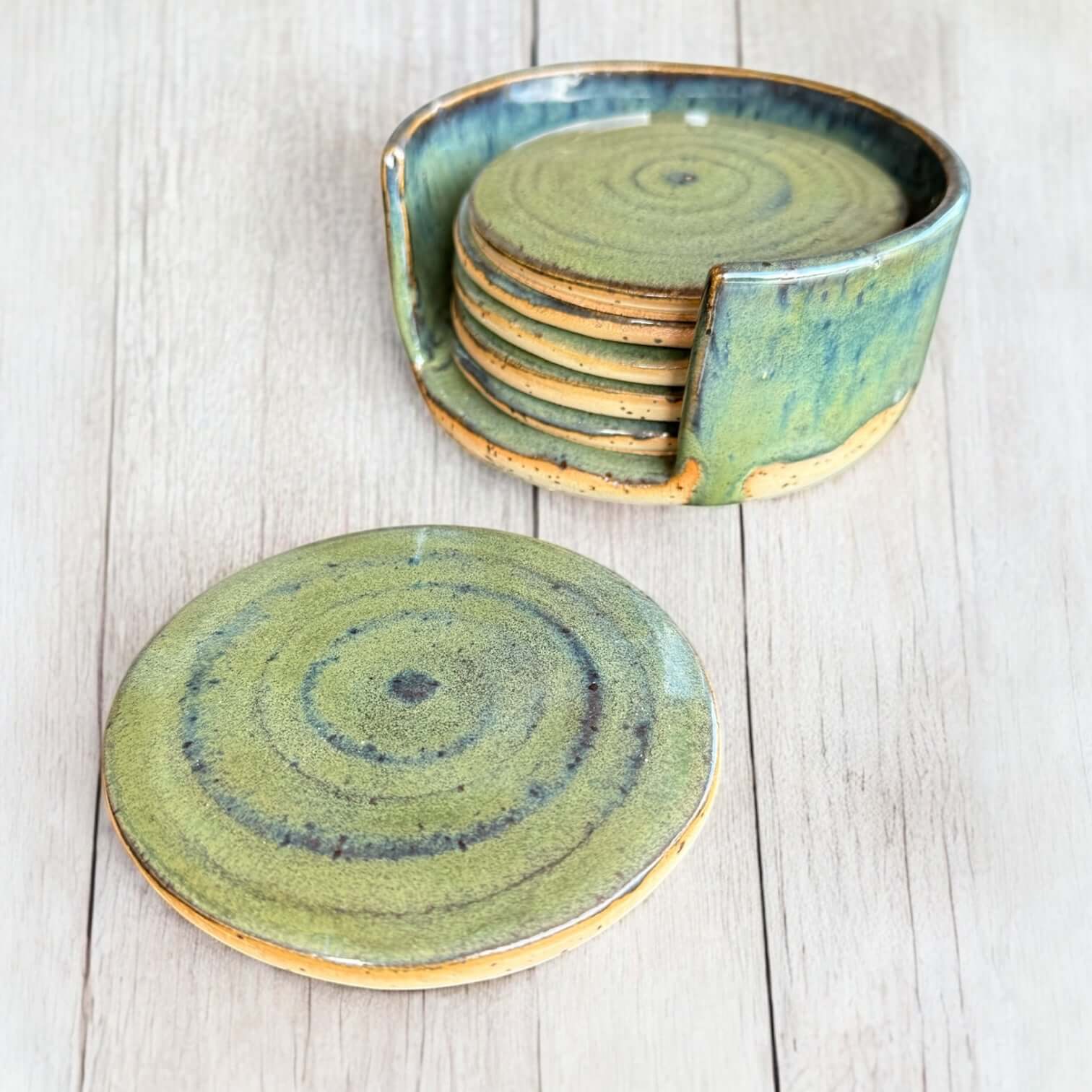 Beautiful Handmade Ceramic Coaster Set in soft green tones with a cork base for protection.