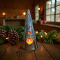 Handmade ceramic tealight tree – glossy winter blue illuminating a cozy space with frosty tones and cut-out patterns.