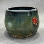 Handmade ceramic cup – green glaze with heart detail